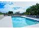 Enjoy the community pool surrounded by lounge chairs and lush landscaping under a sunny, partly cloudy sky at 9630 Club South Cir # 6209, Sarasota, FL 34238