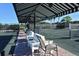 View of a tennis court with benches under an awning at 9630 Club South Cir # 6209, Sarasota, FL 34238
