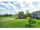 Screened-in lanai offering a beautiful view of the lush green golf course in a private community at 9630 Club South Cir # 6209, Sarasota, FL 34238