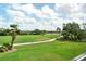 Screened-in lanai offering a beautiful view of the lush green golf course in a private community at 9630 Club South Cir # 6209, Sarasota, FL 34238
