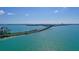 Picturesque aerial view of the bridge, water and sail boats, with city skyline in background at 99 Sunset Dr # 102, Sarasota, FL 34236
