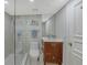 Bathroom with walk-in shower and wood vanity at 99 Sunset Dr # 102, Sarasota, FL 34236