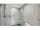 Modern shower with glass door and marble tile at 99 Sunset Dr # 102, Sarasota, FL 34236