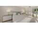 Bedroom with large windows allowing for plenty of sunlight featuring dual nightstands and ocean views at 99 Sunset Dr # 102, Sarasota, FL 34236