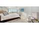 Cozy bedroom with a comfortable bed, sitting area, and an amazing ocean view at 99 Sunset Dr # 102, Sarasota, FL 34236