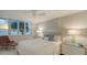Bright bedroom featuring contemporary furniture and large windows overlooking the ocean at 99 Sunset Dr # 102, Sarasota, FL 34236