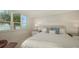 Bedroom with large windows allowing natural light and overlooking the ocean with views of palm trees at 99 Sunset Dr # 102, Sarasota, FL 34236