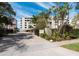 Inviting entrance to Lawrence Pointe Condominiums, showcasing a secure gate and lush tropical landscaping at 99 Sunset Dr # 102, Sarasota, FL 34236