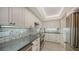Kitchen featuring stainless steel appliances, light gray backsplash, and marble floors at 99 Sunset Dr # 102, Sarasota, FL 34236