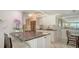 Contemporary kitchen features stainless appliances, gray countertops and a breakfast bar at 99 Sunset Dr # 102, Sarasota, FL 34236