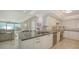 Bright kitchen featuring stainless appliances, granite countertops, and a view of the water from the breakfast bar at 99 Sunset Dr # 102, Sarasota, FL 34236