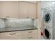 Laundry area with cabinetry, countertop space and stacked washer/dryer at 99 Sunset Dr # 102, Sarasota, FL 34236