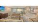 Bright living room features neutral furnishings and expansive sliding glass doors with ocean views at 99 Sunset Dr # 102, Sarasota, FL 34236