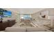 Bright living room features modern decor, comfortable seating, and stunning water views at 99 Sunset Dr # 102, Sarasota, FL 34236