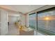 Living room with floor-to-ceiling windows offering stunning views of the water at sunset at 99 Sunset Dr # 102, Sarasota, FL 34236