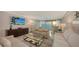 Bright living room features neutral furnishings and expansive sliding glass doors with ocean views at 99 Sunset Dr # 102, Sarasota, FL 34236