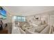 Bright and airy living room boasting water views, marble floors, and elegant neutral decor at 99 Sunset Dr # 102, Sarasota, FL 34236