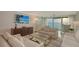Bright living room features neutral furnishings and expansive sliding glass doors with ocean views at 99 Sunset Dr # 102, Sarasota, FL 34236