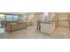 Bright living space featuring modern decor, tile floors, a kitchen island, and an ocean view at 99 Sunset Dr # 102, Sarasota, FL 34236