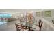 Spacious living space with modern decor, tile floors, water view, and an open floor plan at 99 Sunset Dr # 102, Sarasota, FL 34236