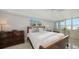 Bright bedroom with water views, marble floors, and tasteful decor at 99 Sunset Dr # 102, Sarasota, FL 34236