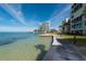 Beautiful oceanfront building with well-manicured green space and crystal clear water at 99 Sunset Dr # 102, Sarasota, FL 34236