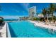 Relaxing outdoor swimming pool with a beautiful view of the bay and surrounding buildings at 99 Sunset Dr # 102, Sarasota, FL 34236
