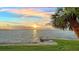 Beautiful waterfront home offers stunning sunset views over the water and lush tropical landscaping at 99 Sunset Dr # 102, Sarasota, FL 34236