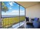 Enjoy the water view from this screened-in balcony with comfortable seating and a table at 1020 Tidewater Shores Loop # 304, Bradenton, FL 34208