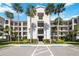 Beautiful condo building featuring palm trees and manicured landscaping in a waterfront community at 1020 Tidewater Shores Loop # 304, Bradenton, FL 34208