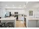 Kitchen with white cabinetry, stainless steel appliances, breakfast bar and tile flooring at 1020 Tidewater Shores Loop # 304, Bradenton, FL 34208