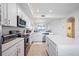 A well-lit kitchen featuring white cabinets, stainless steel appliances, and an island with seating at 1020 Tidewater Shores Loop # 304, Bradenton, FL 34208