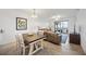 Open living area with dining table and view of water from sliding glass doors to balcony at 1020 Tidewater Shores Loop # 304, Bradenton, FL 34208