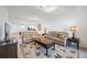 Spacious living area with leather sofas, an area rug, and open to the kitchen at 1020 Tidewater Shores Loop # 304, Bradenton, FL 34208
