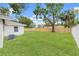 A spacious back yard with lush green grass and a new wooden fence at 1050 55Th S Ave, St Petersburg, FL 33705