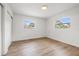 Bright bedroom featuring wood floors and two windows at 1050 55Th S Ave, St Petersburg, FL 33705