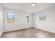 Bright bedroom featuring wood floors and three windows at 1050 55Th S Ave, St Petersburg, FL 33705