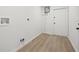 Clean, white laundry room with wood-look flooring and ample space at 1050 55Th S Ave, St Petersburg, FL 33705