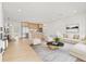 Bright living room with wood floors, light neutral furniture, and combined kitchen and dining areas at 1050 55Th S Ave, St Petersburg, FL 33705