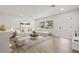 Bright living room featuring white walls, wood floors, and views through a window to the outdoors at 1050 55Th S Ave, St Petersburg, FL 33705