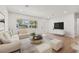 Bright and open living room with white walls, wood floors, and a view to the outside at 1050 55Th S Ave, St Petersburg, FL 33705