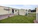 Green grassy backyard featuring a small patio and shed, perfect for outdoor activities and storage at 1110 49Th Avenue W Dr, Bradenton, FL 34207