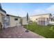 Paver patio and grassy backyard including 2 sheds and an outdoor seating area at 1110 49Th Avenue W Dr, Bradenton, FL 34207