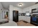 Functional kitchen with white cabinets, black appliances, and tiled backsplash at 1110 49Th Avenue W Dr, Bradenton, FL 34207