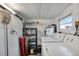 Functional laundry room with washer, dryer, shelving, and storage space at 1110 49Th Avenue W Dr, Bradenton, FL 34207