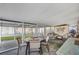 Enclosed patio space with a round table and cushioned seating, providing a versatile outdoor area at 1110 49Th Avenue W Dr, Bradenton, FL 34207