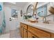Bathroom featuring double sinks, wood cabinets, and a door to the backyard at 11219 93Rd St, Largo, FL 33773