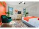 Bright bedroom featuring a comfortable chair, a dresser with TV, and stylish decor at 11219 93Rd St, Largo, FL 33773