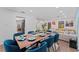 Open dining area featuring a large table set for eight, connecting to the living room and kitchen at 11219 93Rd St, Largo, FL 33773