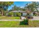 Charming single-story home with fresh landscaping, including palm trees and a well-maintained lawn at 11219 93Rd St, Largo, FL 33773